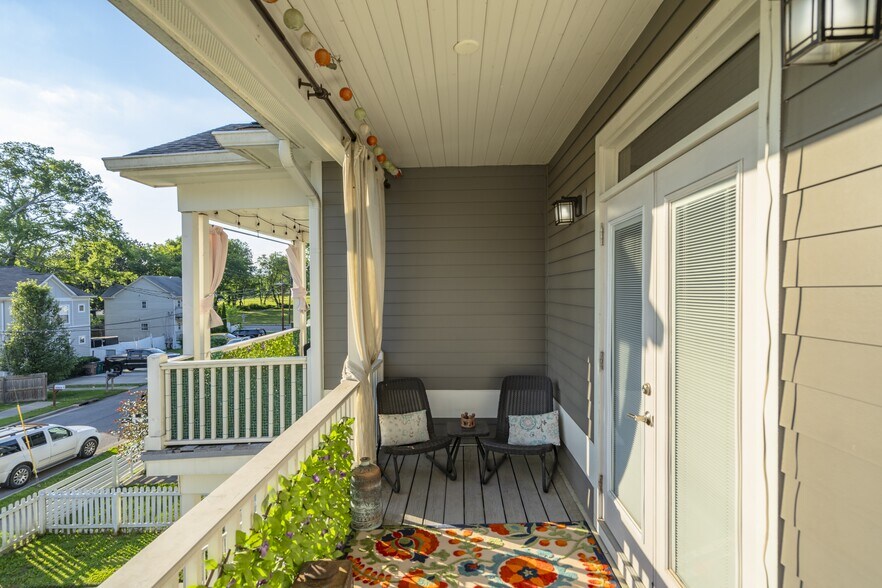 3rd Bedroom Walk out Balcony with seating and privacy curtains - 1922 14th Ave N