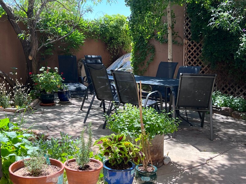 "Oasis" patio, flowering chipalta tree, flowers, herbs - 56 Oshara Blvd