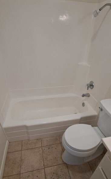 2nd full bathroom with tub and shower. New medicine cabinet and toilet. Porcelain tile floors. - 314 20th St