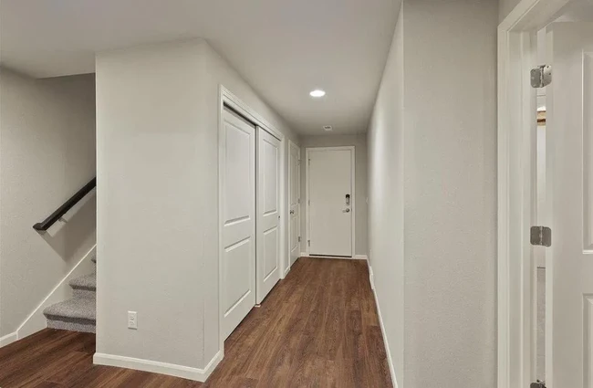 Basement hallway walkout to garage with two storage rooms + bonus room - 5856 Lien Rd