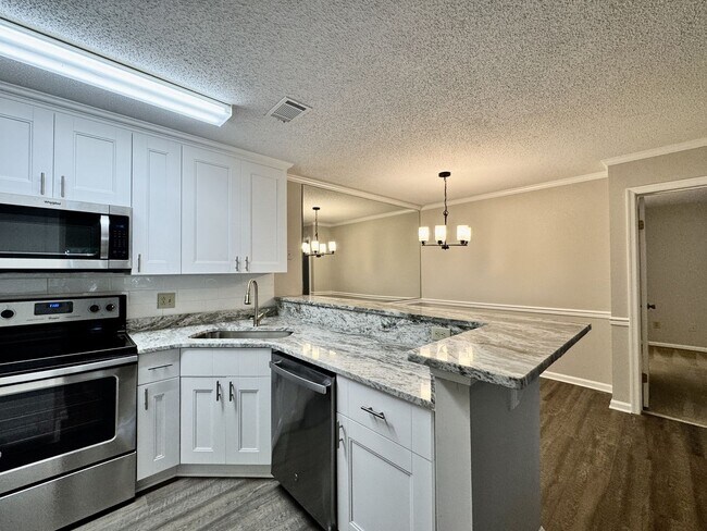 Building Photo - Updated 1st Floor/1-Level Condo Available NOW & Rent Includes Water, Sewer, Trash, Landscaping, F...