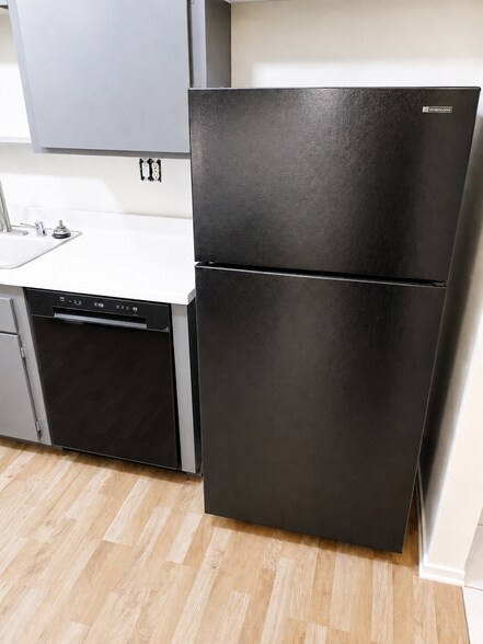 Kitchen includes updated dishwasher, refrigerator, cabinet storage, and easy-access counter space. - 339 E Taft Ave