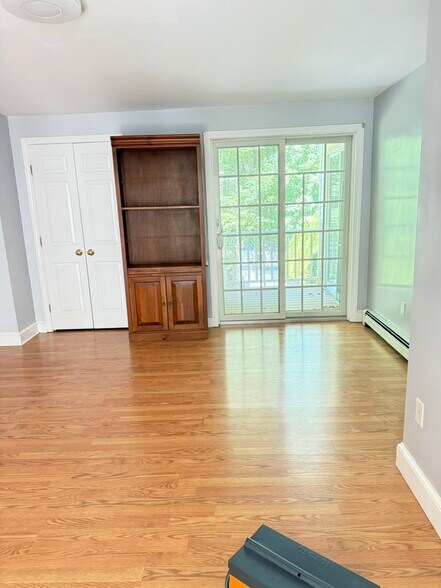 Bedroom w/ sliders out to covered balcony facing woods. Walk-in closet on the left - 20 Partridge Ln