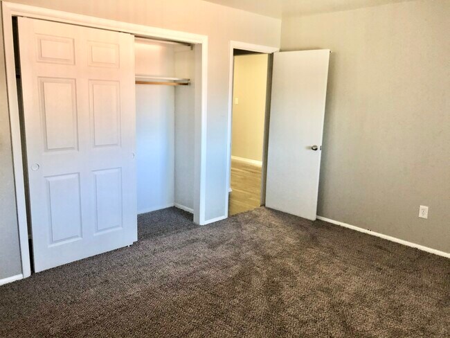 Step into this inviting bedroom with a roomy closet space and plush carpeting. - GRACE LANDINGS APARTMENTS