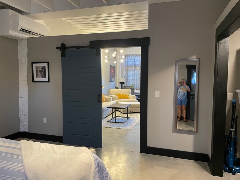 Bedroom with barn door, storage closet, full length mirror. - 475 S Hickory St