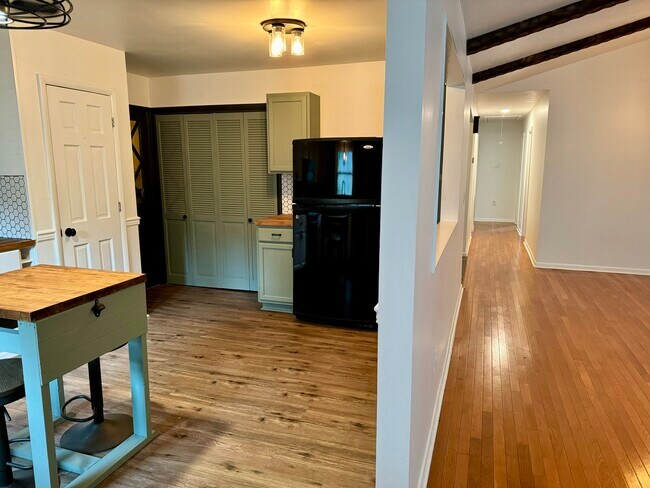 View to exit to flex and garage space (left) and down hallway to bedrooms (right) - 6111 Northlakes Dr