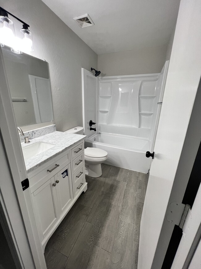 Marble Vanity and eco flush toilet, and newly installed shower/tub - 8268 W Magnum Dr