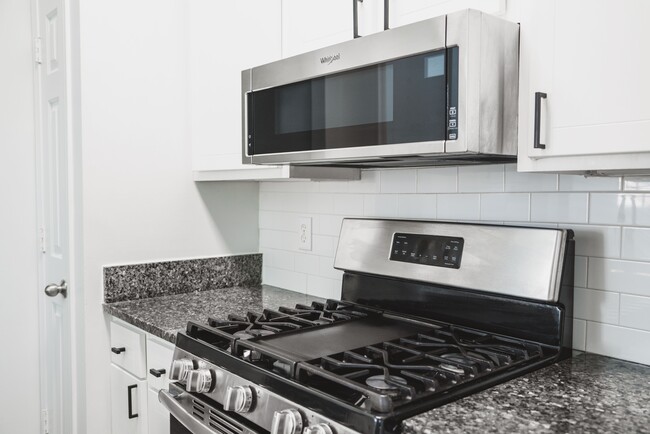 Stainless-steel appliances with granite countertops - Alister Lake Lynn