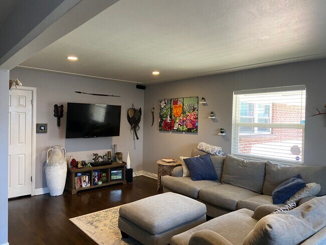 Living room when you first walk in, mounted TV included - 3425 Tejon St