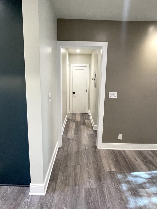 Hallway toward the bathroom on the left and bedroom on the right and nest thermostat with app access - 3211 W Alameda Ave