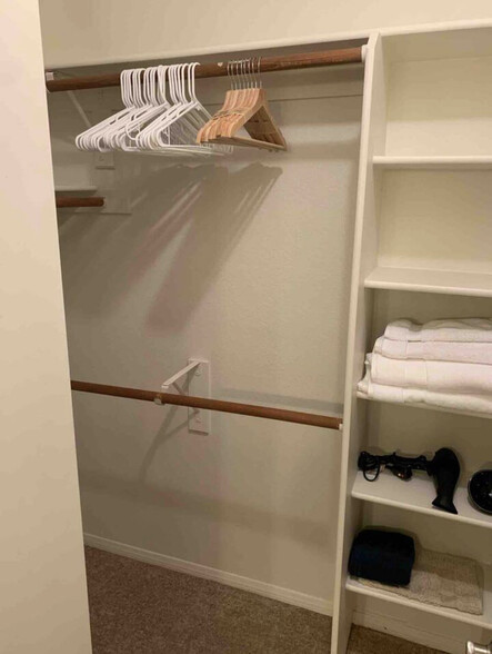 Walk-in closet in Primary Bedroom - 1825 W Ray Rd