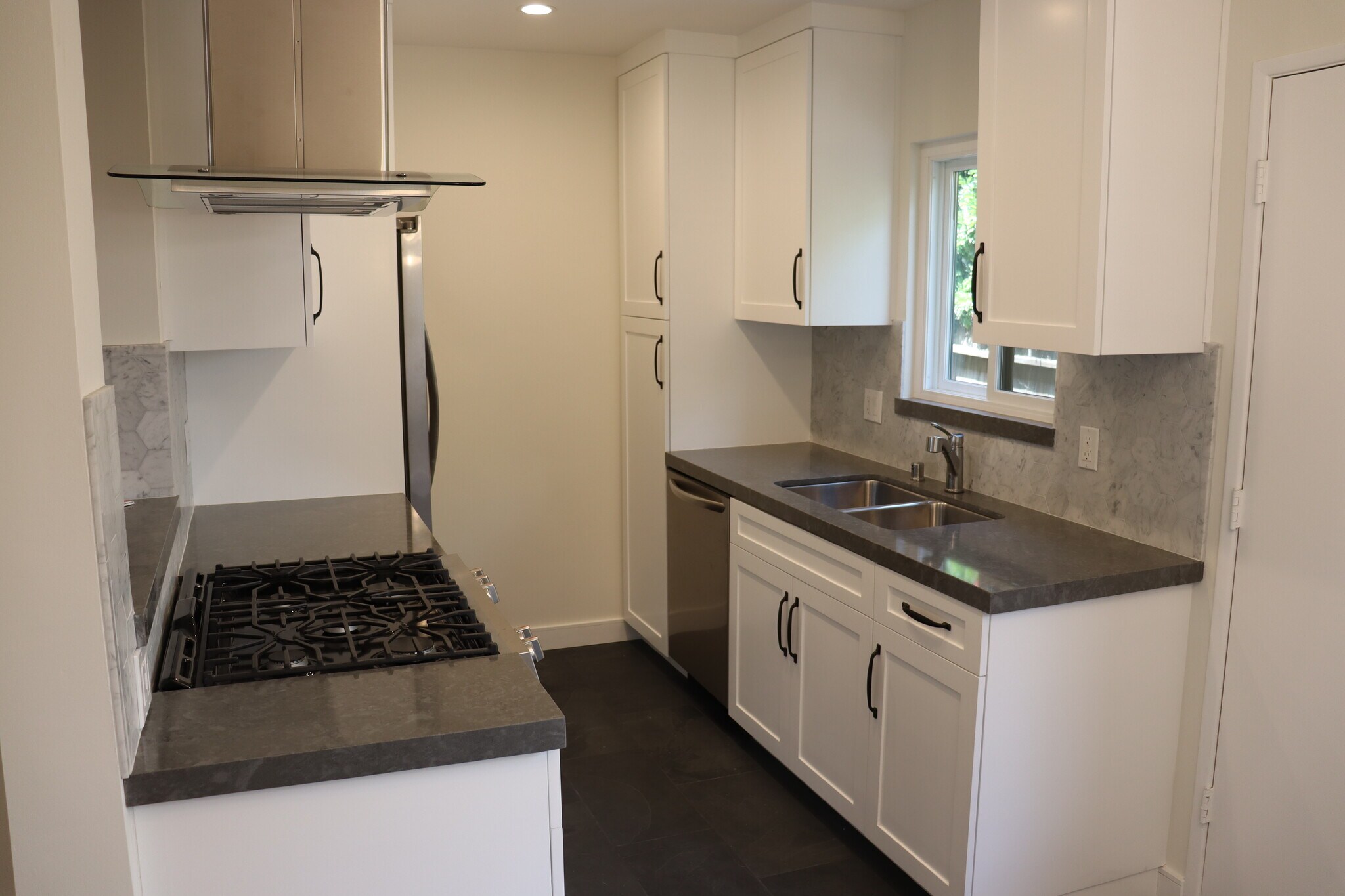 Kitchen with stainless steel appliances, including dishwasher. - 3617 Wesley St