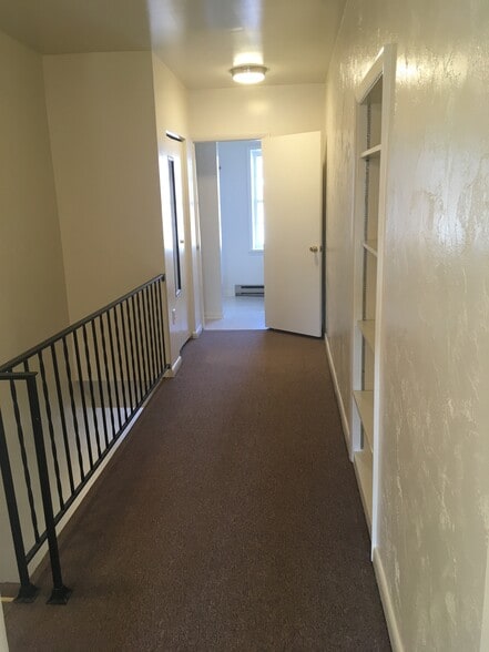 2nd floor hallway leading to the bathroom with a closet and built in wall shelving - 316 East Patrick Street