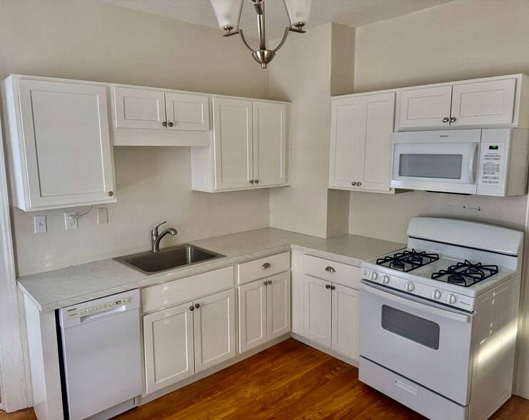 Full open kitchen with dishwasher and built-in microwave over the stove with oven - 52 Genesee St