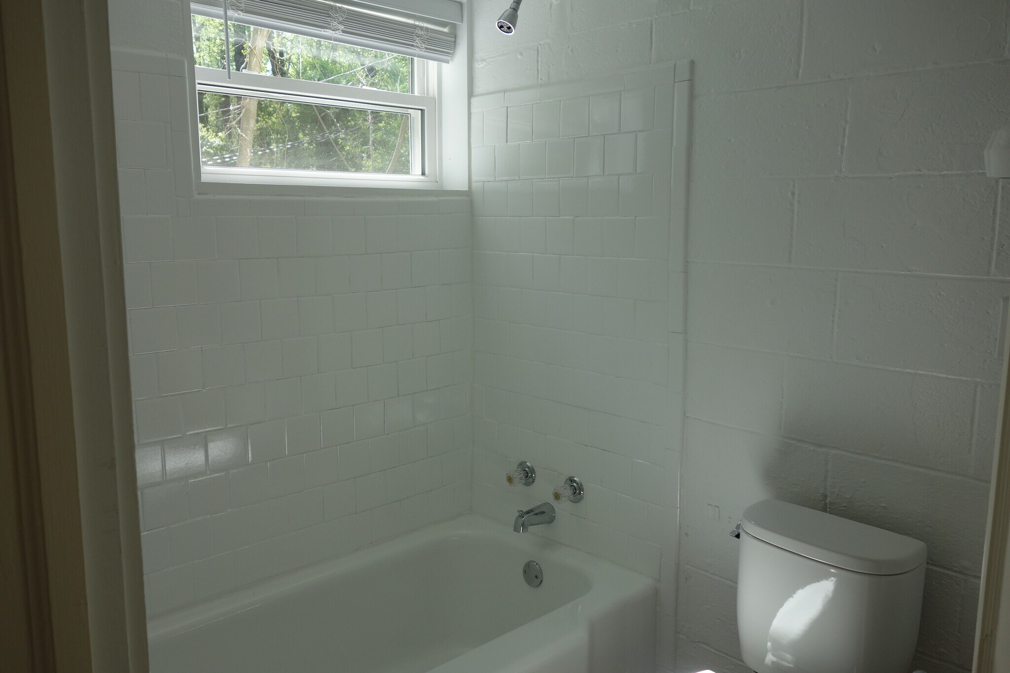Completely refinished bathroom with new toilet and sink. - 116 Howard Dr