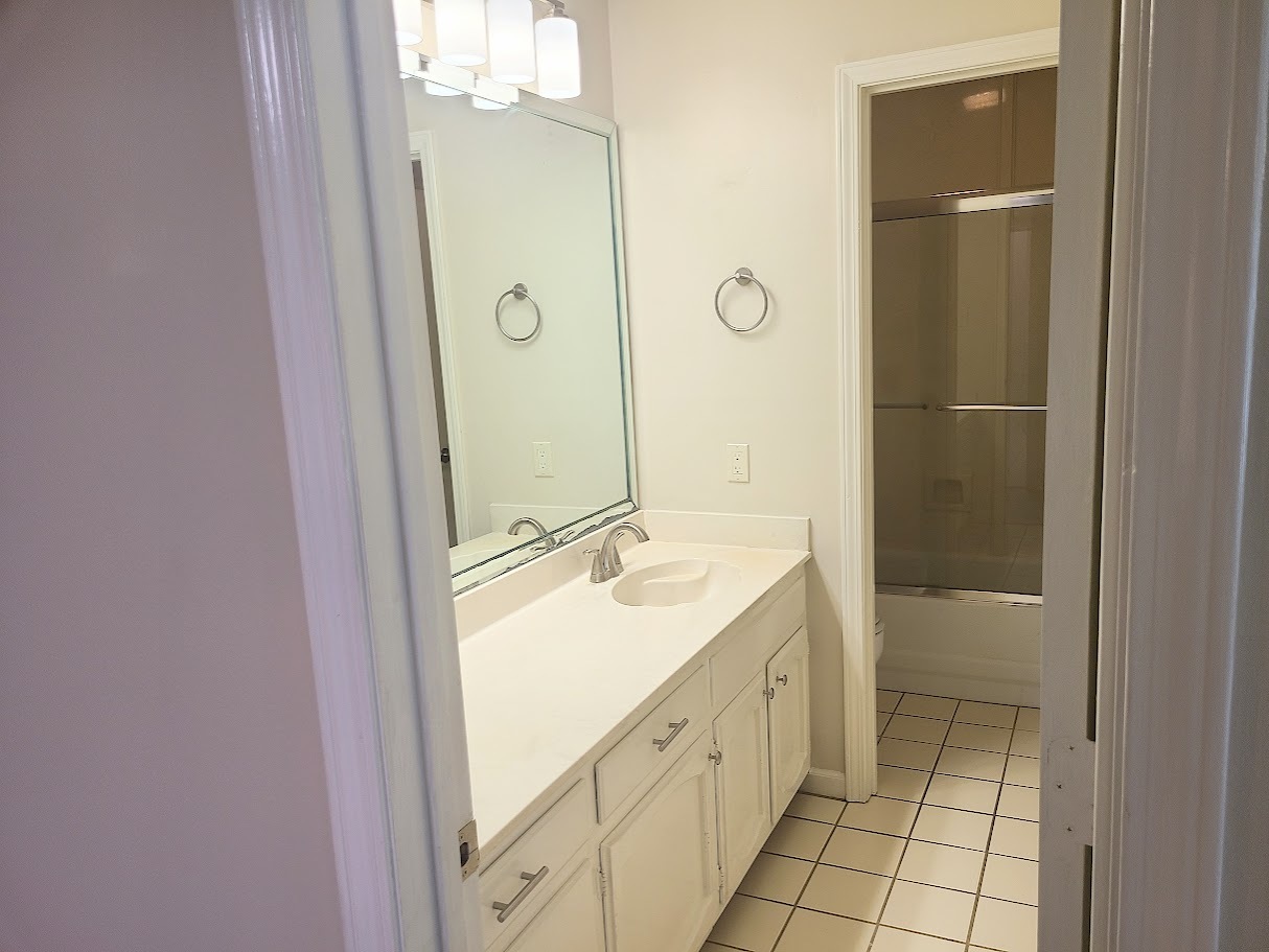 Guest bathroom in hallway with a tub/shower combo and tons of storage - 12439 Coursey Blvd
