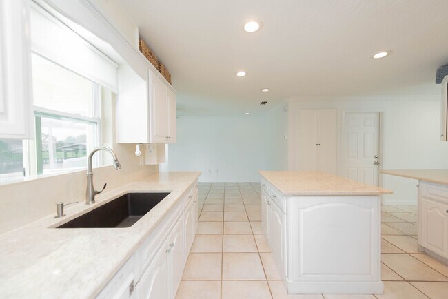 Building Photo - Live the ultimate Space Coast waterfront lifestyle at this stunning beachside canal home in Satel...