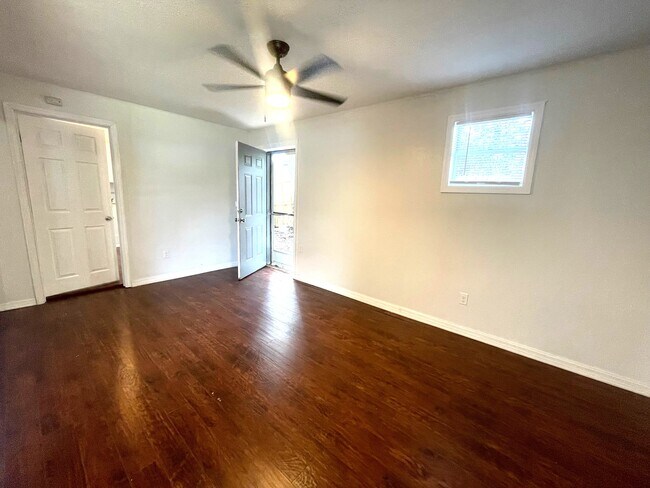 second living room and door to laundry room and exterior side door - 6604 S Mascotte St
