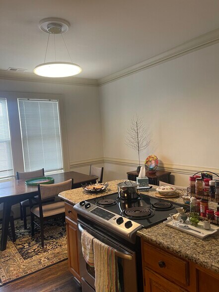 kitchen with granite counters and island with stove - 418 Clement Ave