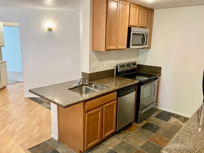 Building Photo - One Bedroom with Garage and IN-Unit laundry in Resort-Style Complex