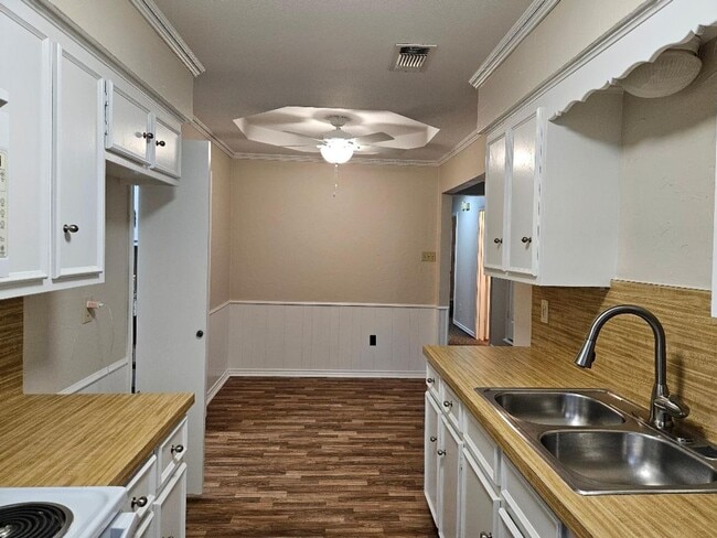 Building Photo - Three bedroom and two bathroom nicely remodeled with new flooring. Large wood fenced backyard