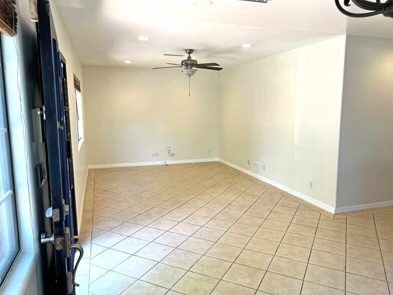Living room from dining area. Main entrance on the left with kitchen and living area to the right. - 2330 S Mansfield Ave
