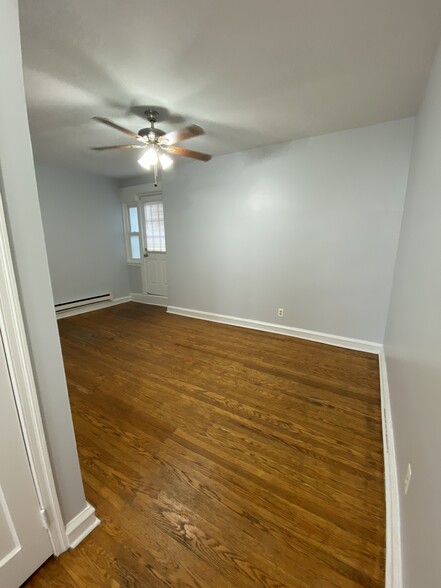 Bedroom ceiling fan fire escape door byond the ceiling fan - 114 E Main St