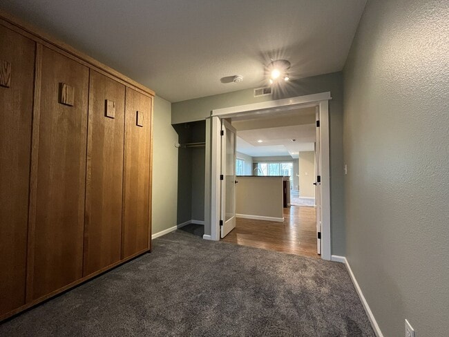 Building Photo - Ground Floor End Unit on Jantzen Beach with River Views & Flexible Living Space