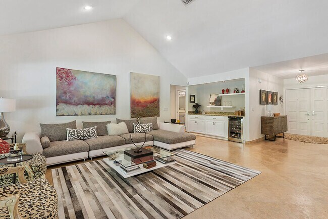 Living room features bar area with refrigerator and sink for entertaining - 2535 NW 41st St