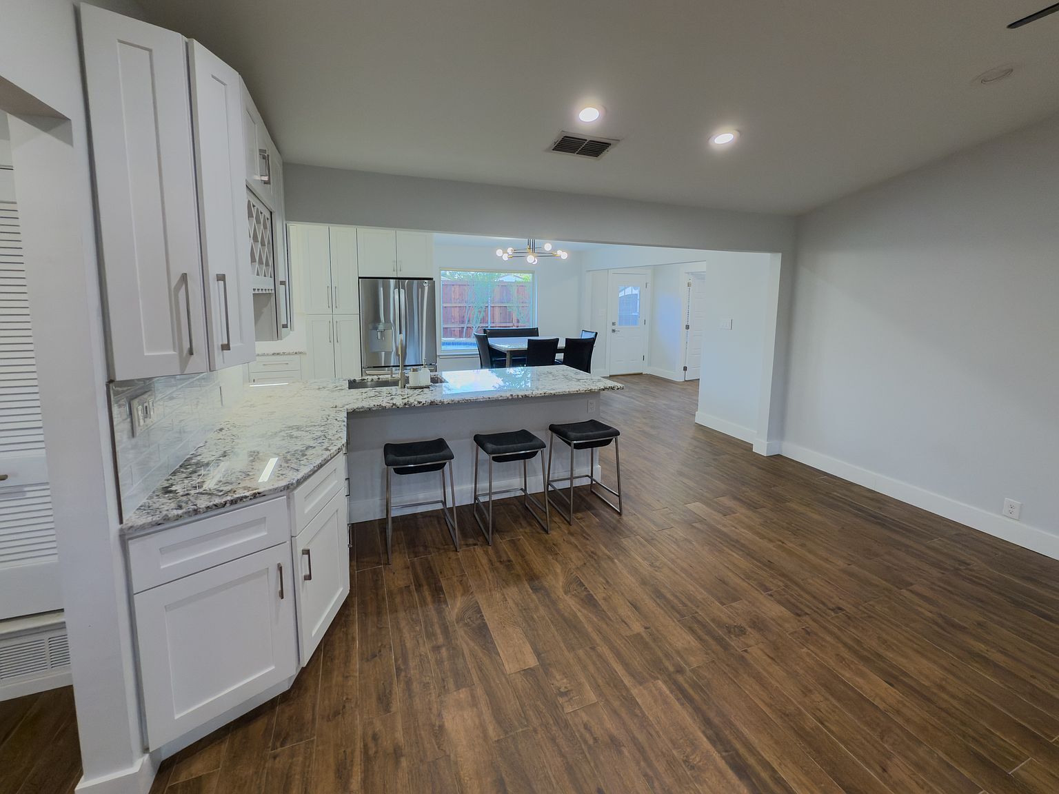 Kitchen island with granite countertops and bar seating - 2006 Candle Ct