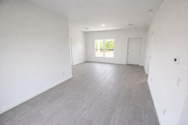 Building Photo - BRAND NEW MODERN SF HOME 3BD+den/2BA with GARAGE IN LEHIGH ACRES!