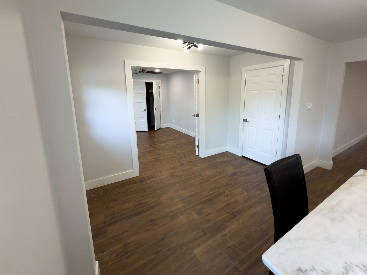 Hallway with hardwood floors and track lighting - 2006 Candle Ct
