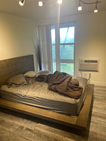 Bedroom with furnished pine wood bed framed - 2300 Sunset Heights Dr