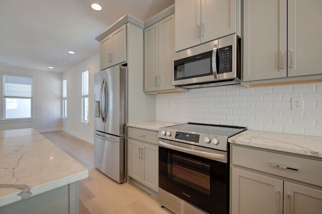 Building Photo - COMING SOON! Modern End-Unit Living Near Uptown | Rooftop Terrace + Tandem Garage