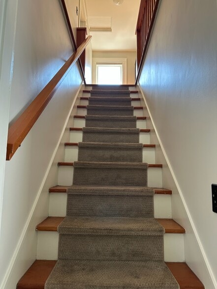 Stairs to upper level - 211 W Boston St