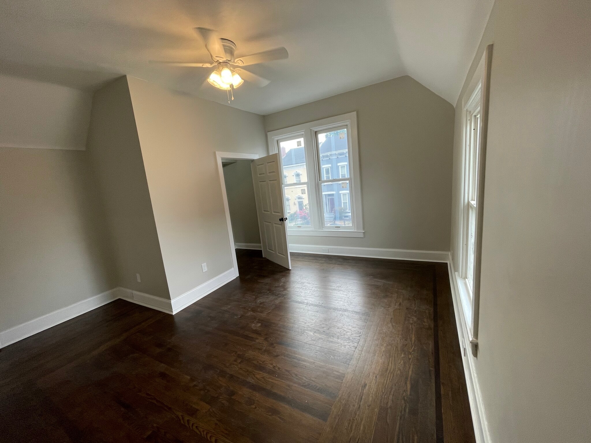 The large primary bedroom featurs original hardwood floors and walk-in closet - 308 Center St