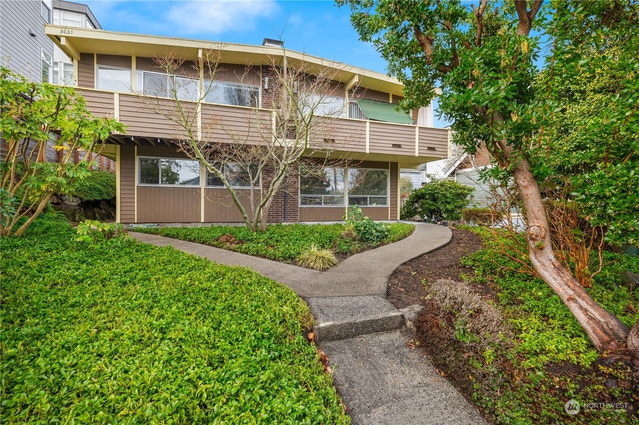 Live in a midcentury modern building with convenient access to the bus, groceries, and restaurants. - 3033 21st Ave W