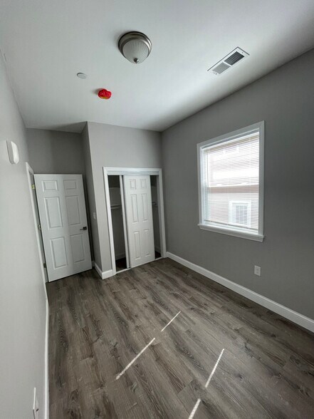 Unit two: bedroom two with closet and easy-clean window with child-safe blinds. - 34 Falcon St