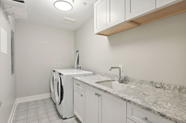 In-unit washer and dryer with ample space in the laundry room - 222 Ferndale Rd S