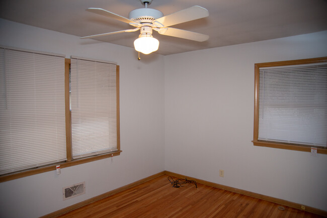 Main level bedroom with ceiling fan. - 1911 Talmage Ave SE