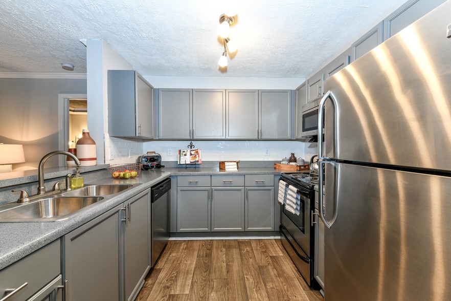 Classic Upgrade: Gray finish with Stainless Steel appliances, and updated lighting - xCrestmark Apartment Homes