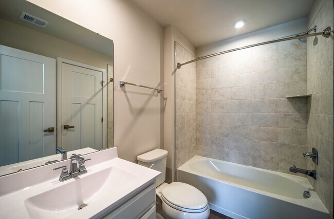 Building Photo - This 3-bedroom, 3-full bathroom townhouse offers a pristine and contemporary living experience.