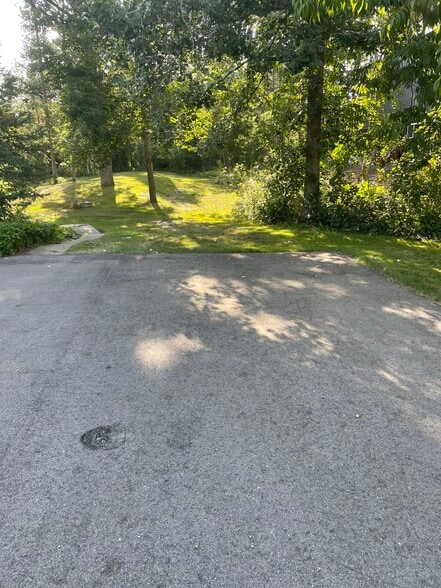 Offstreet parking near walkway to apartment. - 5223 Birchmont Dr NE