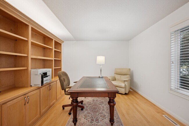 Additional den area located off the kitchen with built-in cabinets - 145 Holly Ln N