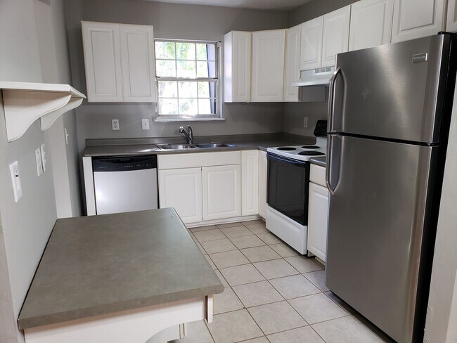 Building Photo - Beautifully updated townhome with stainless steel appliances and wood floors!