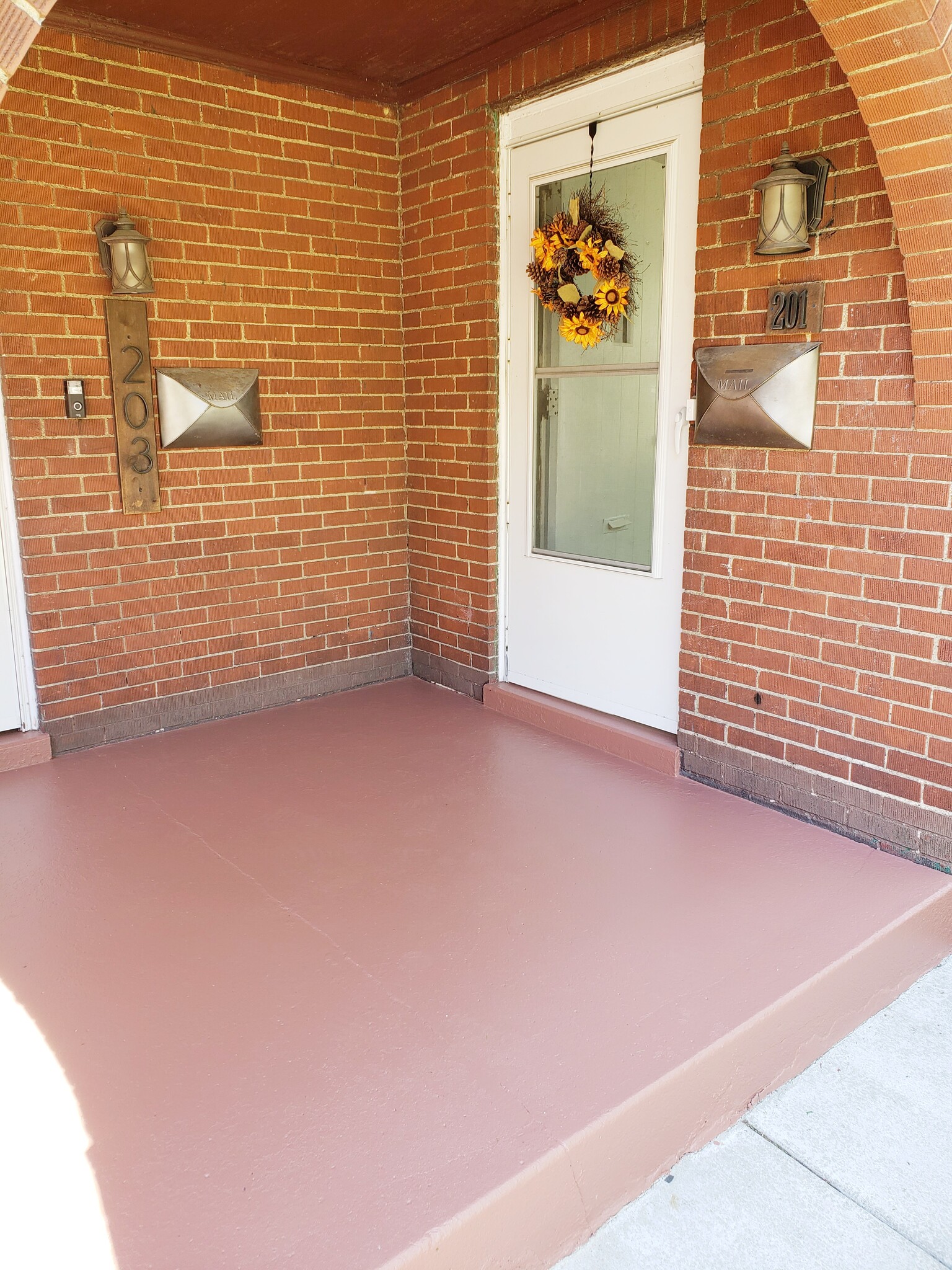 Welcoming porch with Ring doorbell, mailbox, and single-step entry. - 201 Richbarn Rd