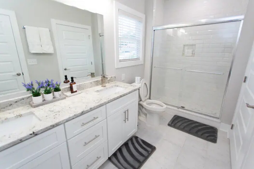 Primary Bathroom: Dual-sink vanity, granite countertops, and a spacious walk-in shower. - 421 Elysian Fields Rd
