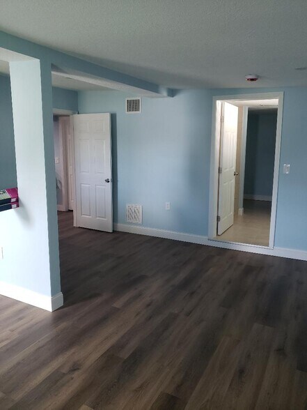 Bedroom with walkway to bathroom - 6001 Cresthill Dr