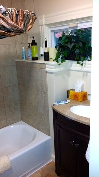 Bathroom with tiled walls and ceramic tub - 58 Maple St