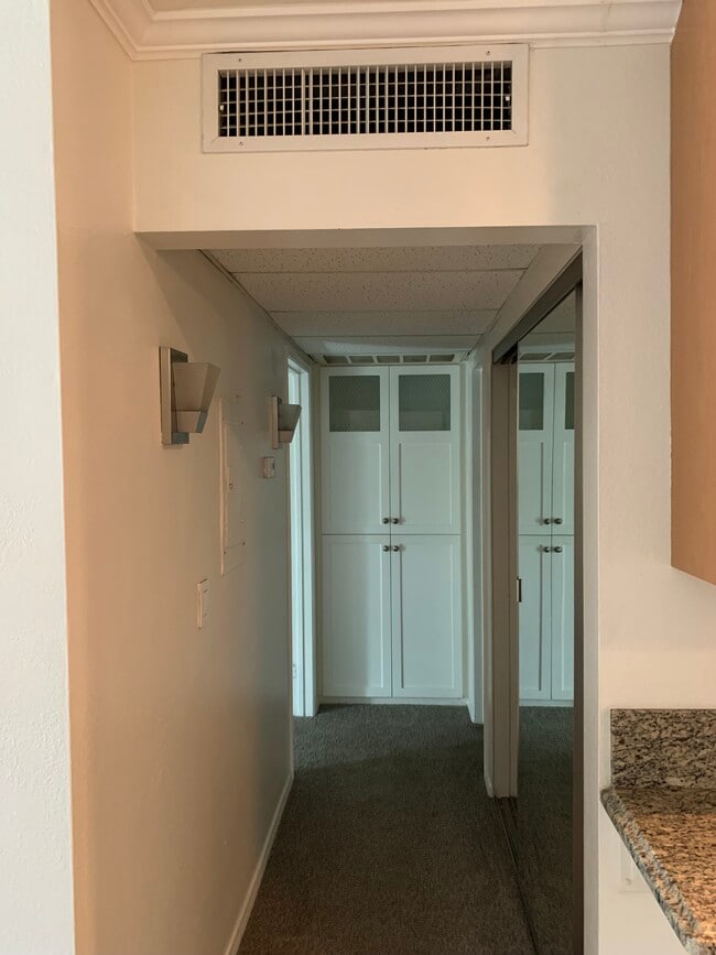 Hallway to bath and bedroom with storage - 436 N Bellflower Blvd